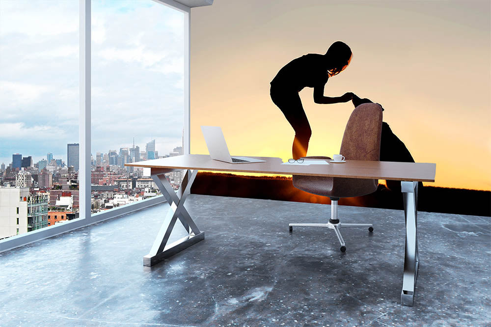 A silhouette of a girl sitting outside in the grass with her pet German Shepherd Mix Dog feeding him treats during training in front of a sunsetting sky. Wall Mural Wallpaper - Canvas Art Rocks - 3