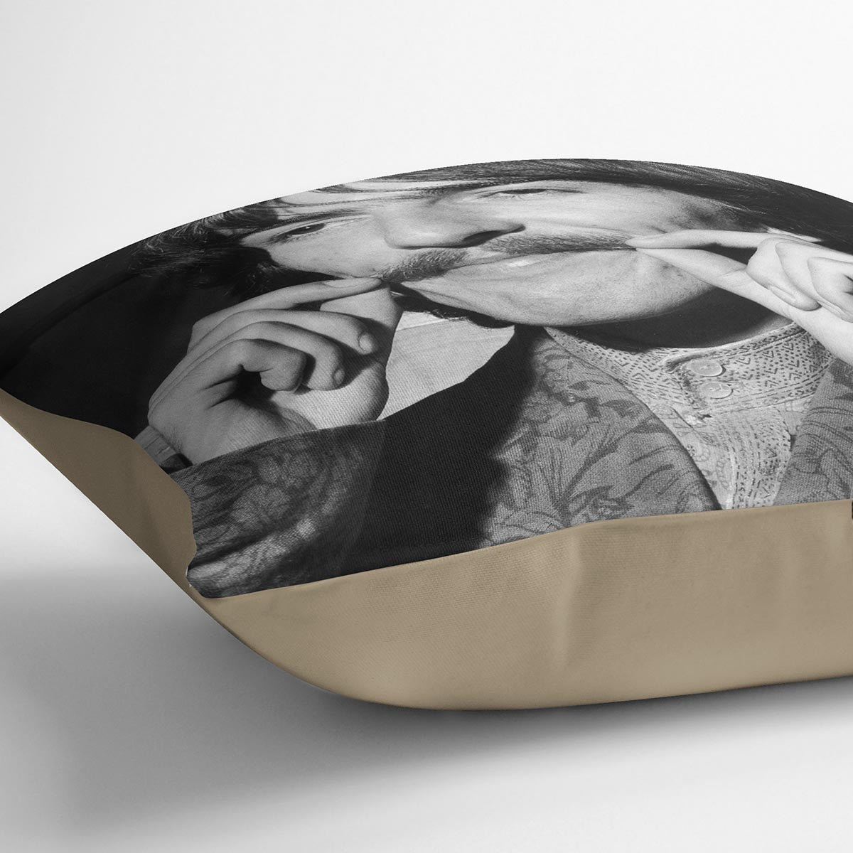 George Harrison plays with his moustache Cushion