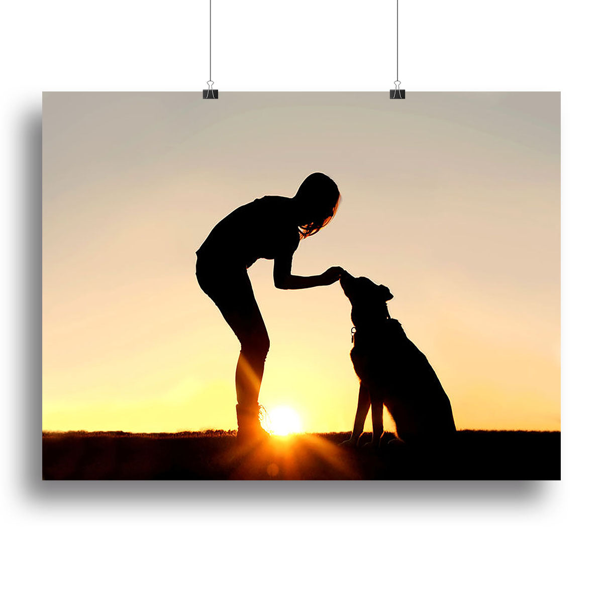 A silhouette of a girl sitting outside in the grass with her pet German Shepherd Mix Dog feeding him treats during training in front of a sunsetting sky. Canvas Print or Poster - Canvas Art Rocks - 2