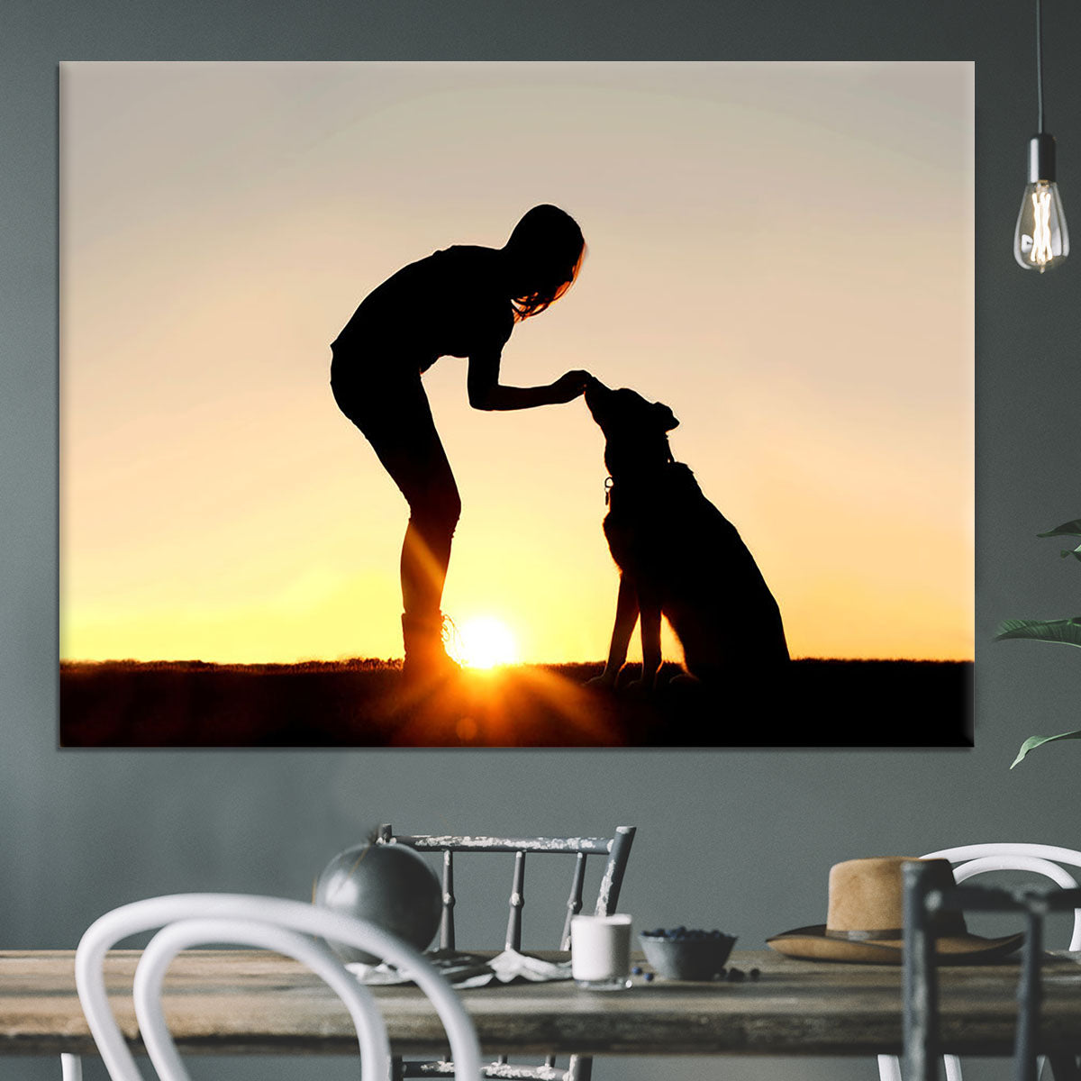 A silhouette of a girl sitting outside in the grass with her pet German Shepherd Mix Dog feeding him treats during training in front of a sunsetting sky. Canvas Print or Poster - Canvas Art Rocks - 3