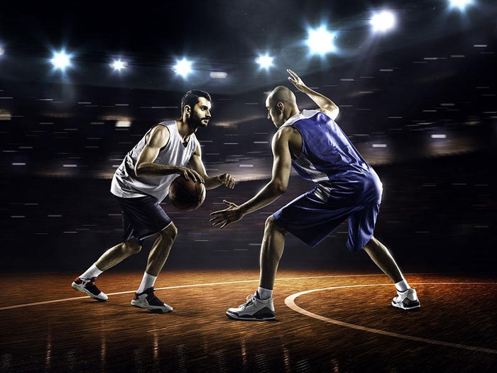 Basketball players in action in gym Wall Mural Wallpaper