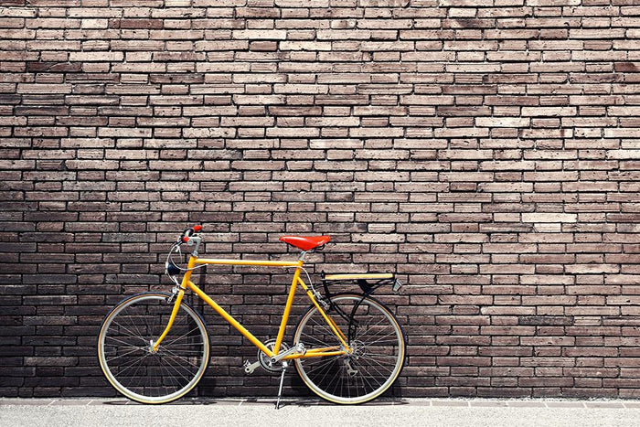 Bicycle on roadside with vintage brick Wall Mural Wallpaper