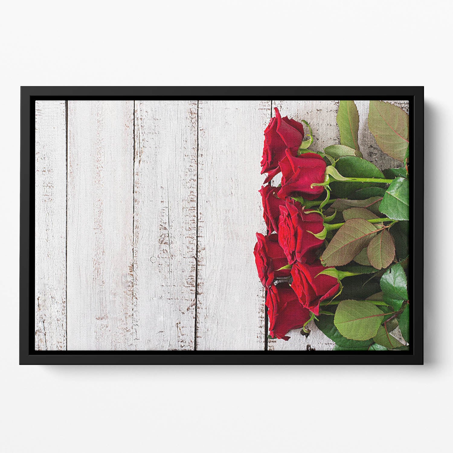 Bouquet of red roses on a light wooden background Floating Framed Canvas