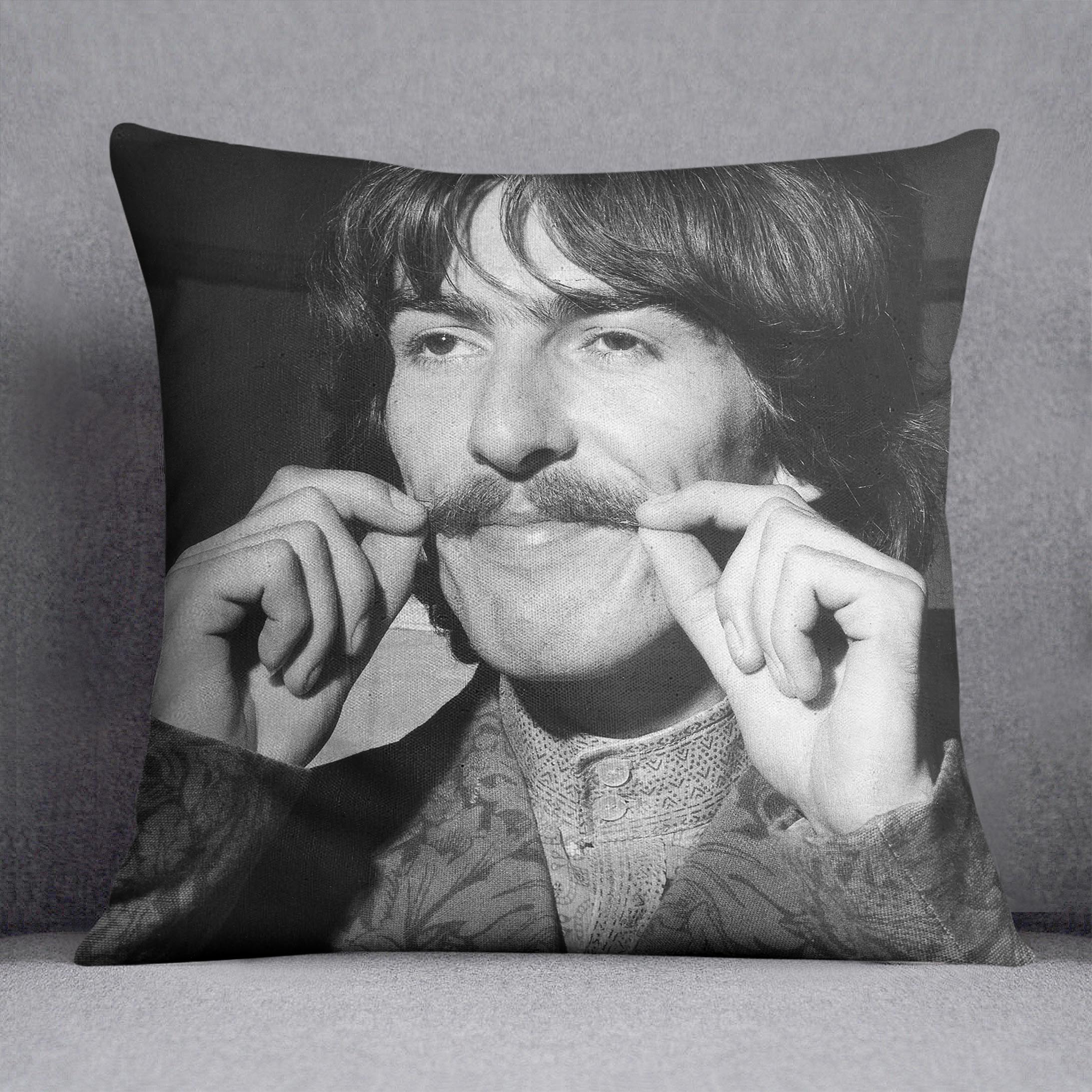 George Harrison plays with his moustache Cushion