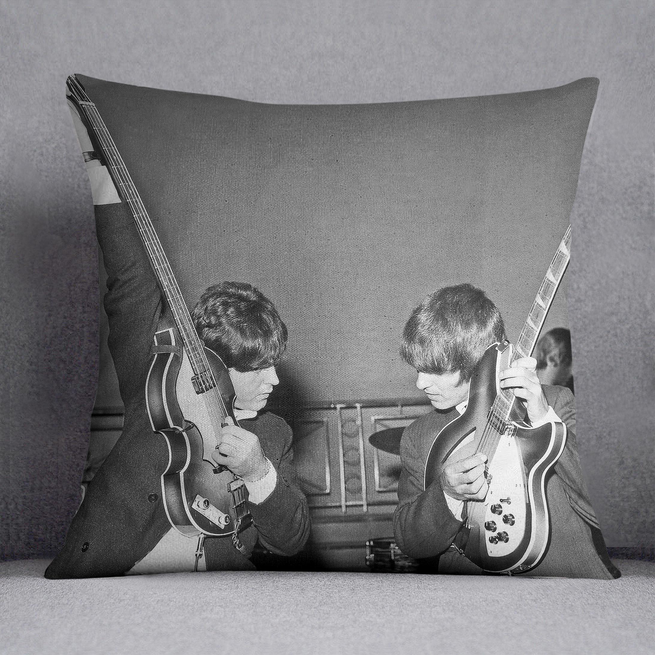 Paul McCartney and George Harrison tune their guitars Cushion