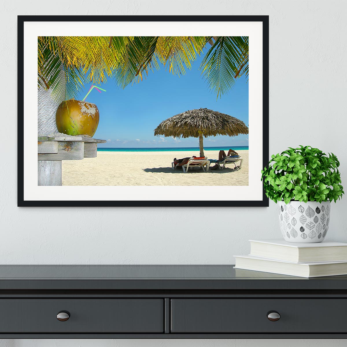 People relaxing under tropical huts with coconut Framed Print - Canvas Art Rocks - 1