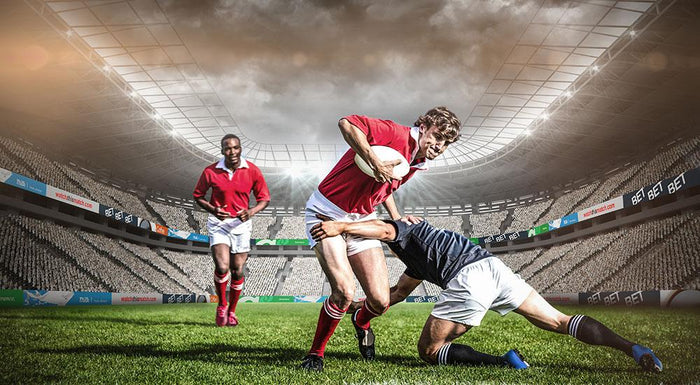 Rugby players tackling during game Wall Mural Wallpaper
