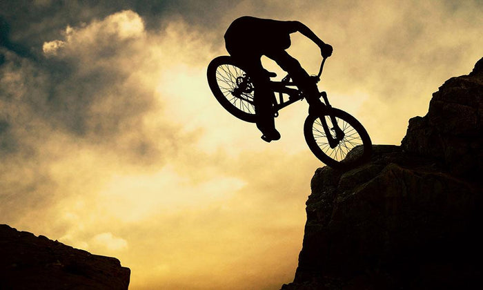Silhouette of a man on muontain-bike Wall Mural Wallpaper