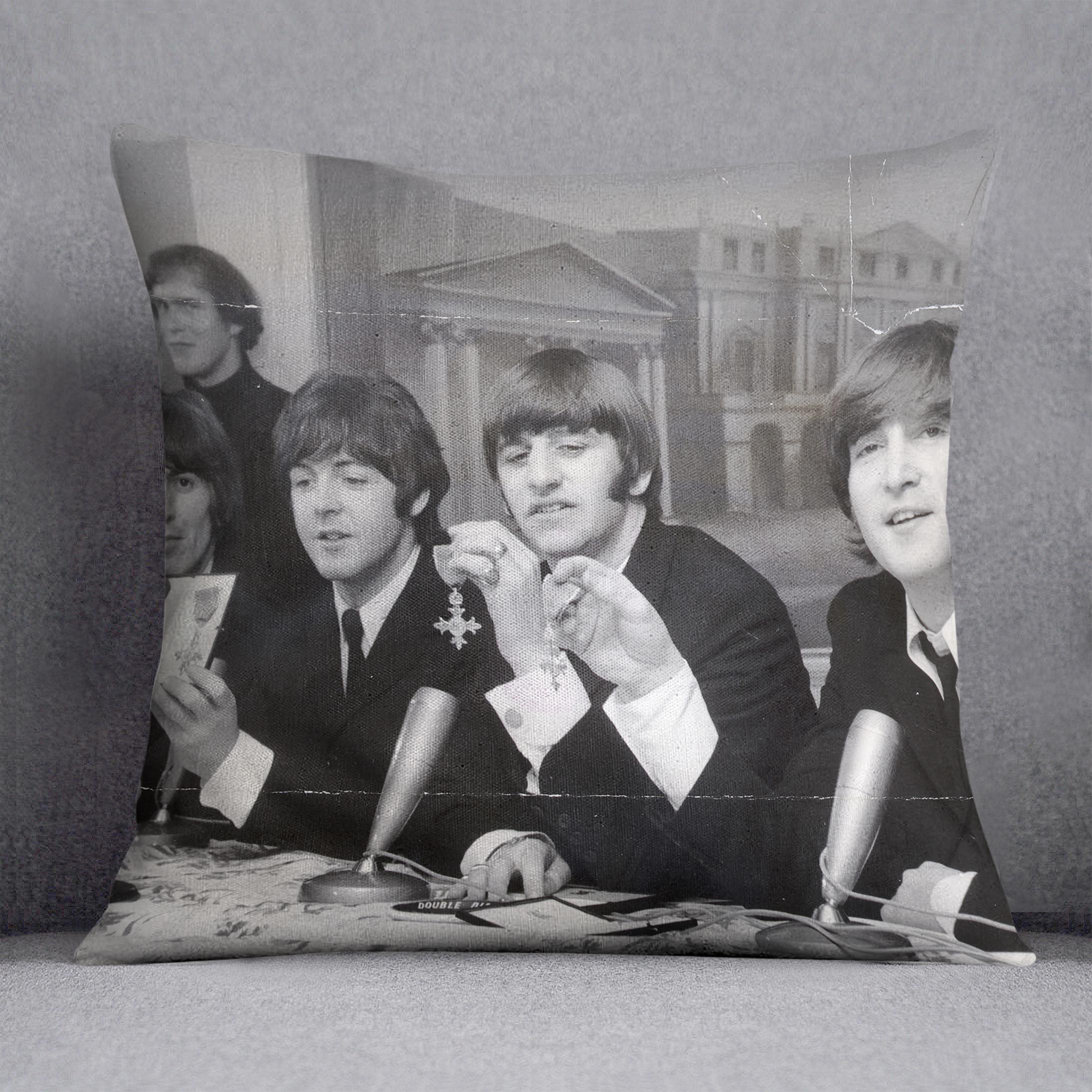 The Beatles at a press conference with their MBEs Cushion