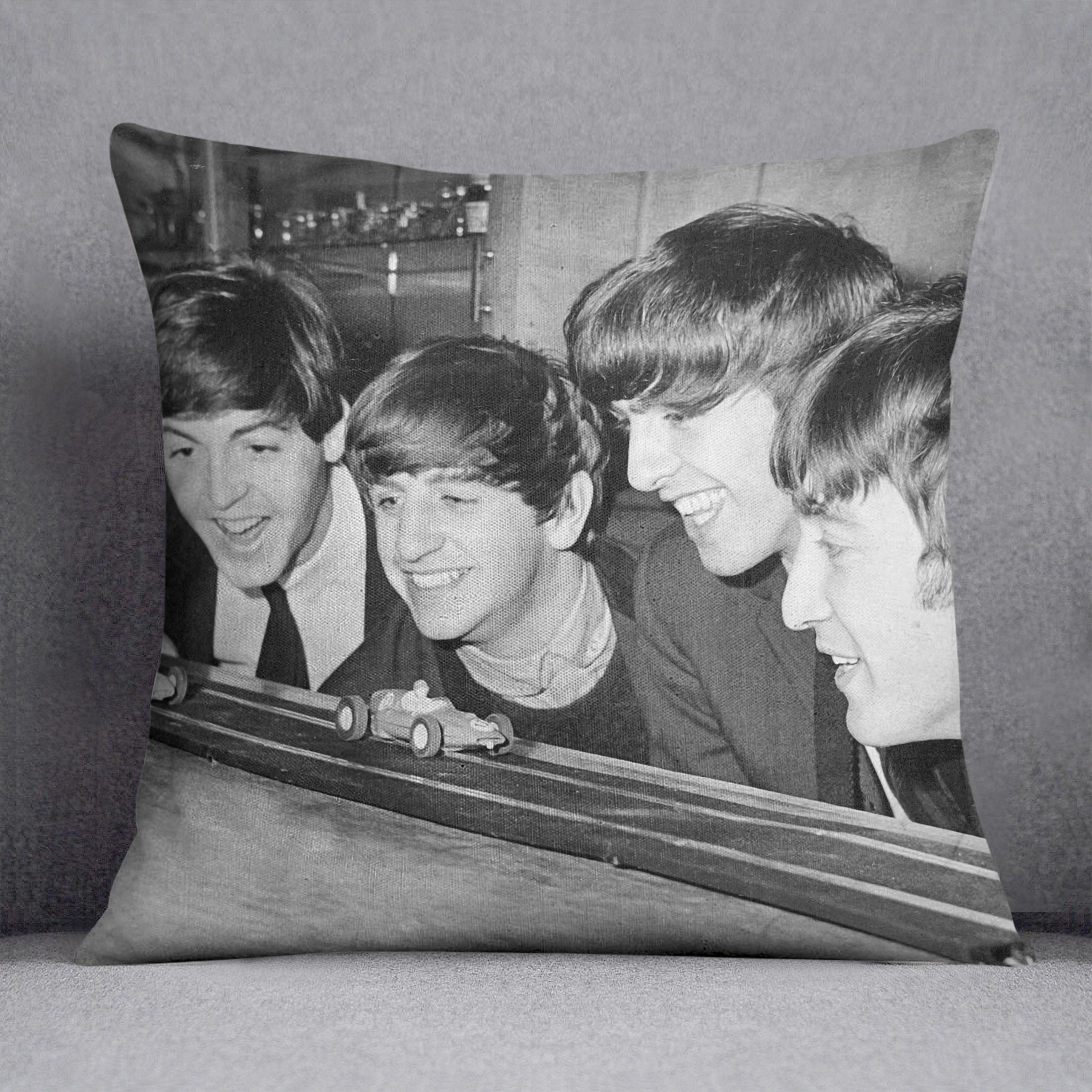 The Beatles play with toy racing cars Cushion