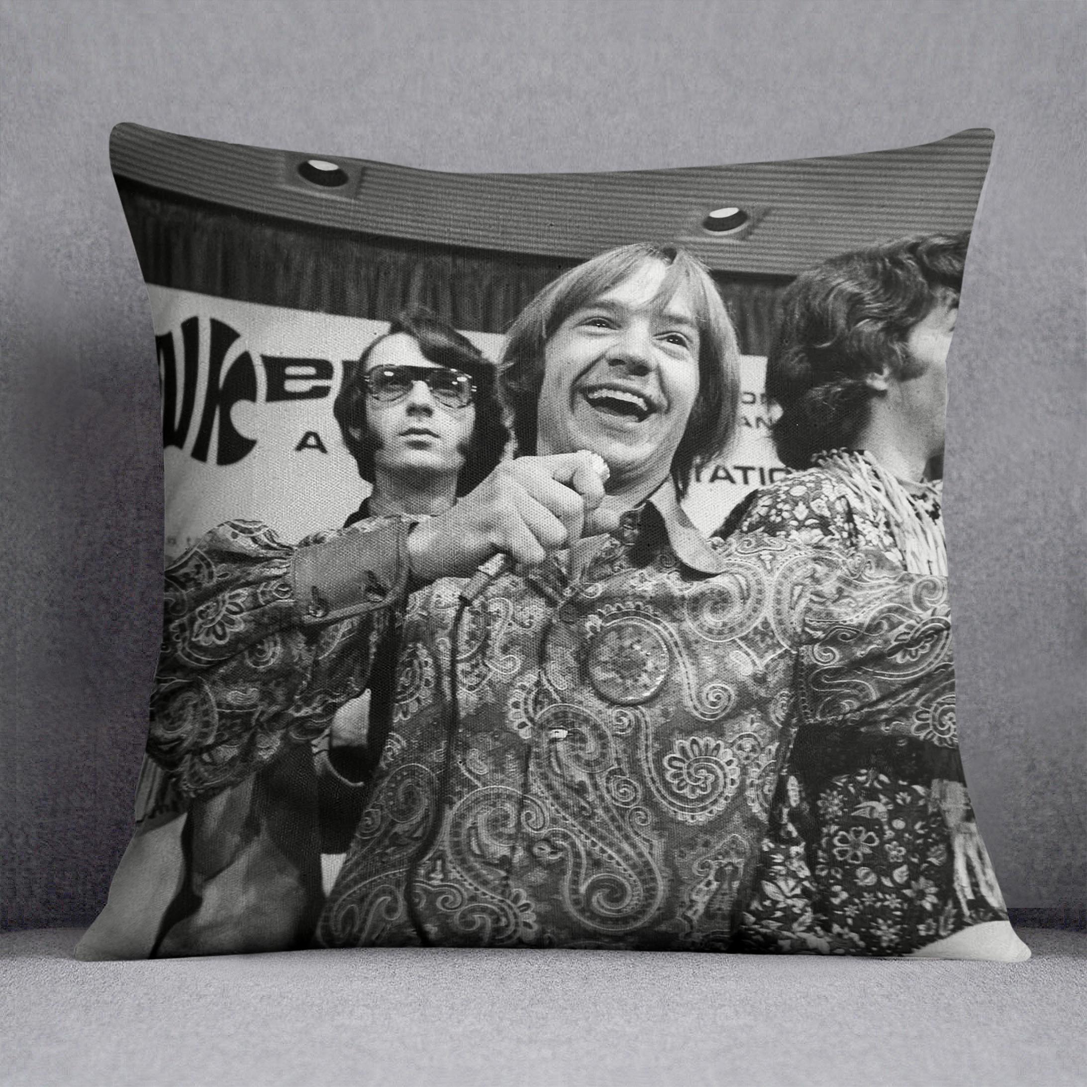 The Monkees playing around Cushion