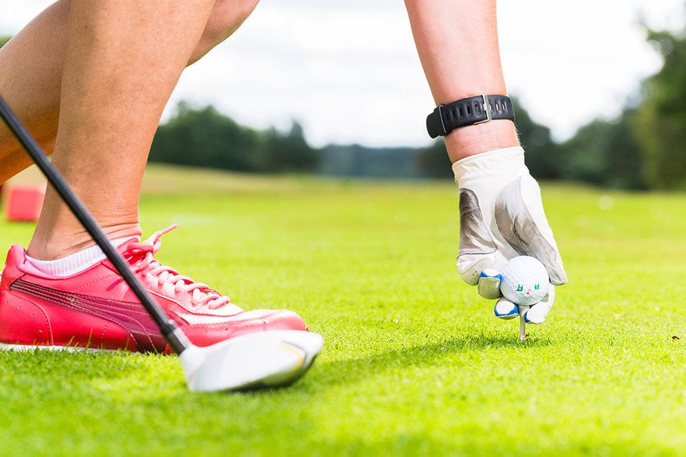 Woman putting golf ball on tee Wall Mural Wallpaper - Canvas Art Rocks - 1