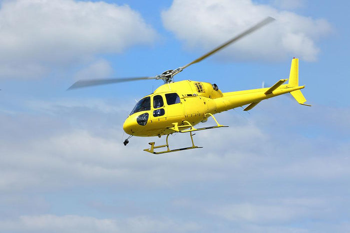 Yellow helicopter in the air Wall Mural Wallpaper
